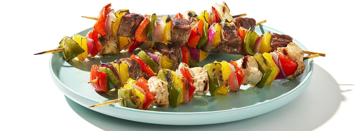 Marinated chicken and beef kabobs with vegetables