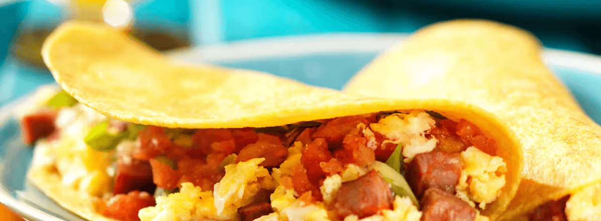 <p>breakfast taco with scrambled egg, sausage and salsa filling</p>