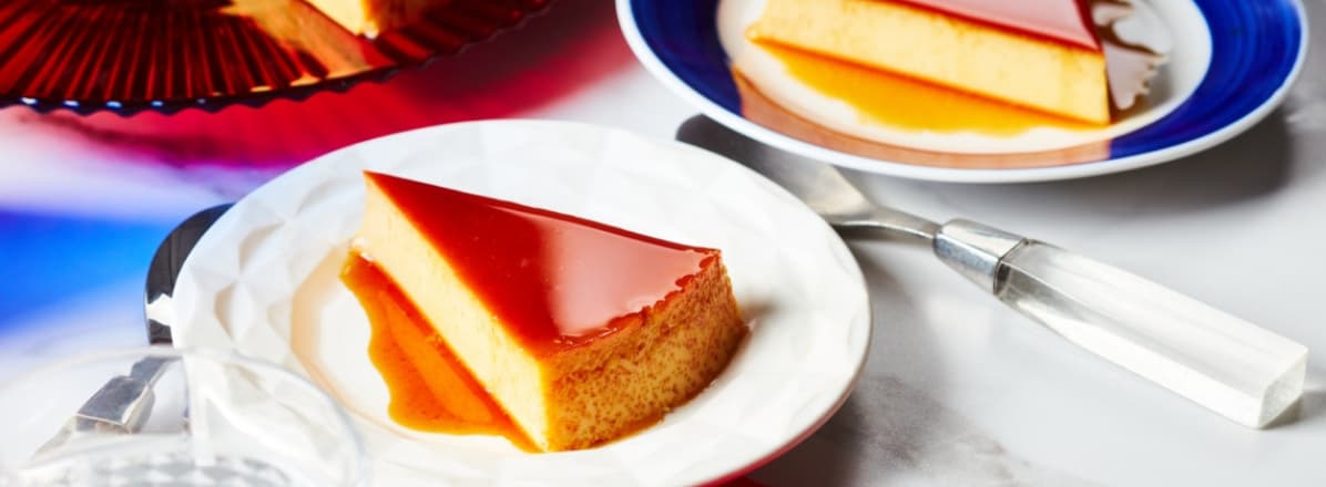 Slice of Mexican inspired flan on plate with whole flan in background