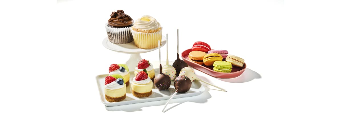 Mini Patisseries like cupcakes, mini cheesecakes, cake pops, and more on platters