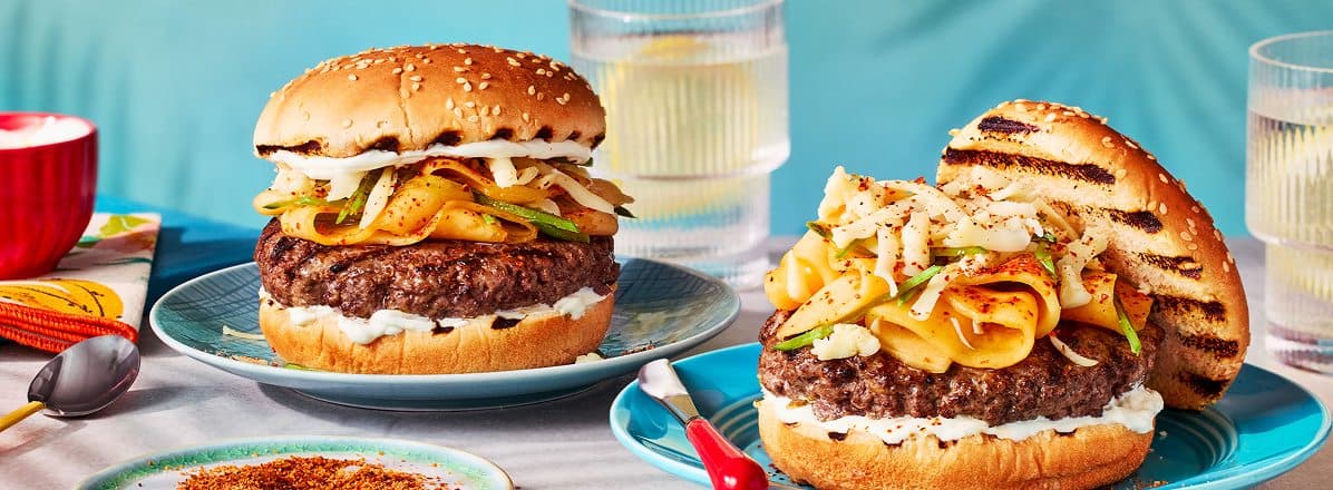 Side profile of two beef burgers with crema, Melon, Snap Peas, Tajin & Cojita Cheese