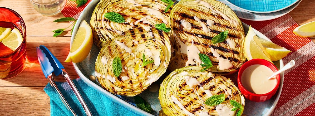 Three cabbages grilled drizzled with a tahini sauce