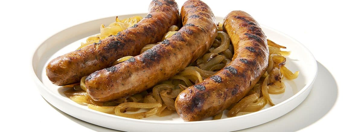 Three sausages on white plate