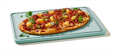 Flatbread pizza topped with al pastor pulled pork, pineapple, jalapenos, red onion and cilantro.