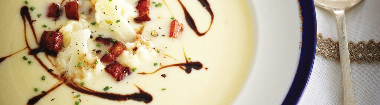 cauliflower soup, topped with balsamic glaze, fresh chives and bacon