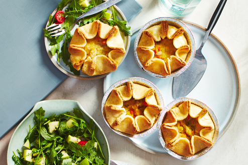 Golden baked chicken Pot Pies on Table.