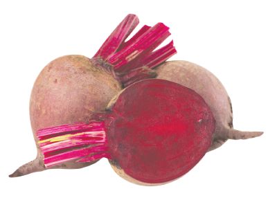 Trio of beets with one of them cut in half on a white counter.