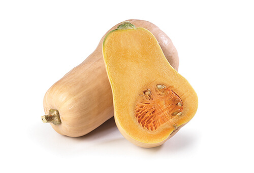 One butternut squash and one cut in half on a white background.