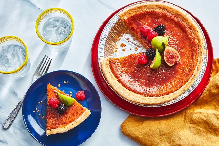 BrÃ»lÃ©ed Pumpkin Pie topped with fresh fruit, with a side plate of pumpkin pie topped with fresh fruit