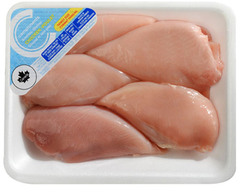 Value-size chicken breasts in a white tray with a blue Compliments label on it.