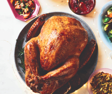 Roasted turkey on a white platter.