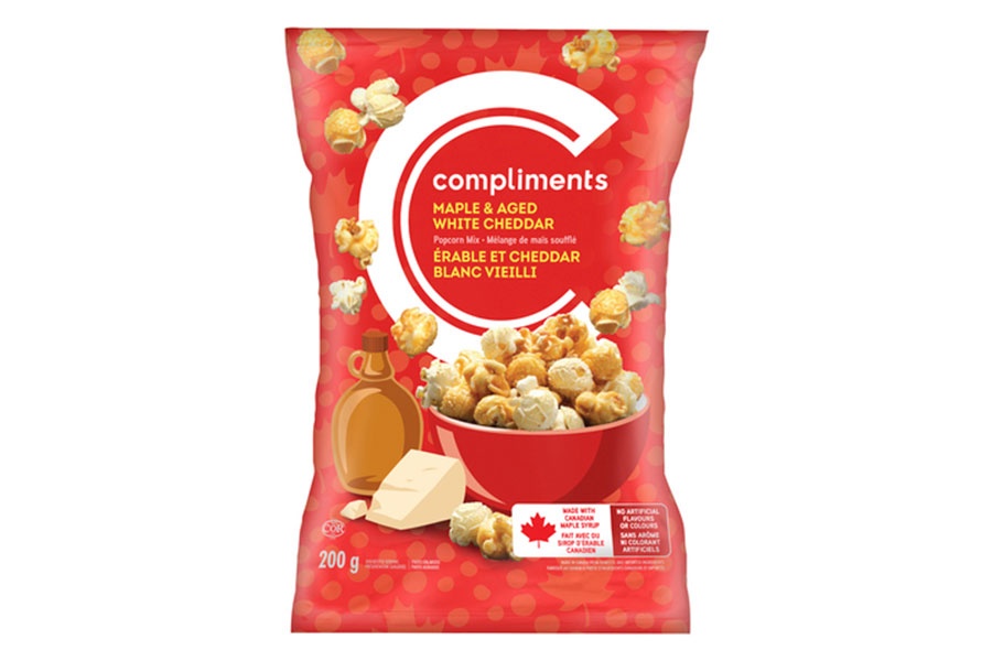 Red bag of Compliments Aged Maple & Aged White Cheddar Popcorn Mix