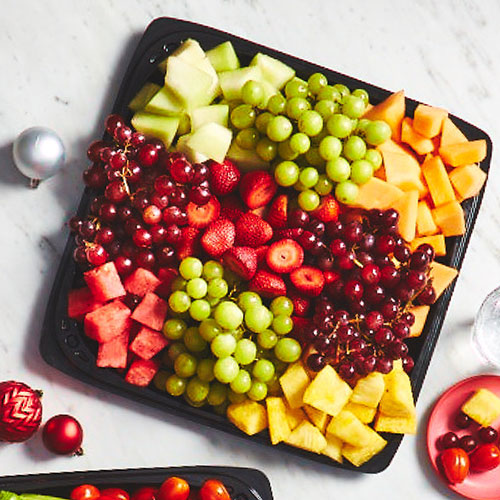 Marble surface with black tray of mixed fruits