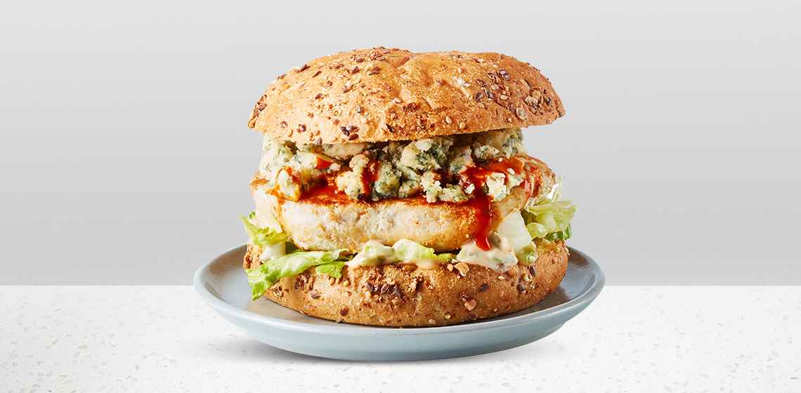 Buffalo Chicken Burger: seeded kaiser bun, Compliments Balance Extra Lean Chicken Burger covered in hot sauce, shredded iceberg lettuce, blue cheese, and Buffalo Mayo.