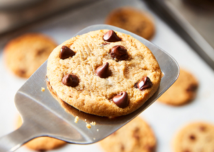 metal spatula with a freshly baked chocolate chip cookie on it