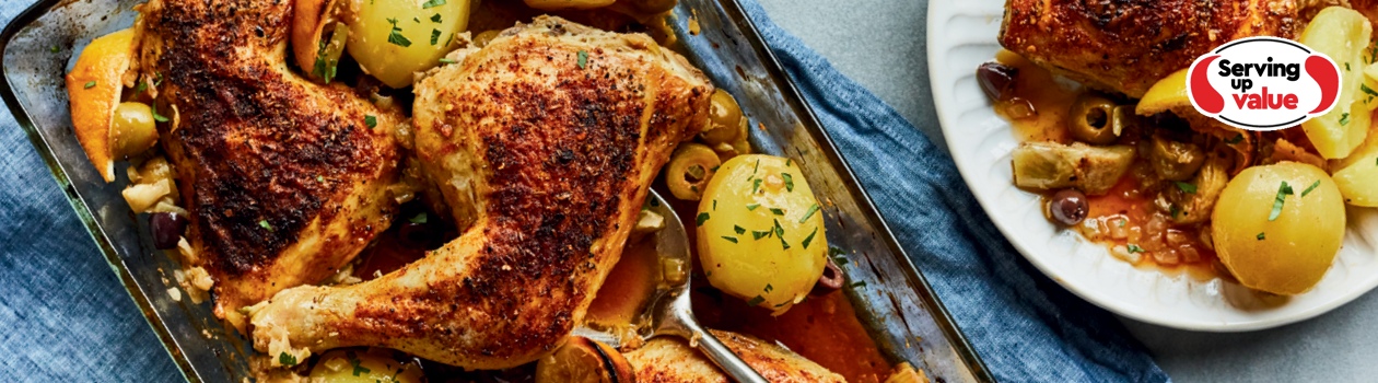 casserole dish of roasted chicken legs with olives and artichokes